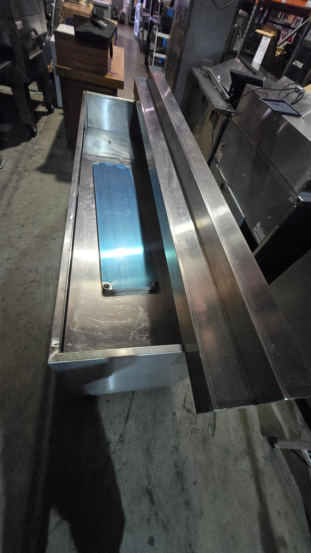 Commercial-grade Stainless Steel Service Counter With An Detached Upper Shelving Unit.