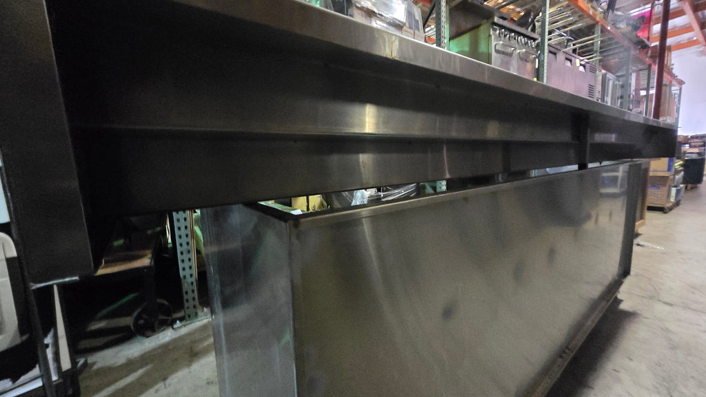 Commercial-grade Stainless Steel Service Counter With An Detached Upper Shelving Unit.