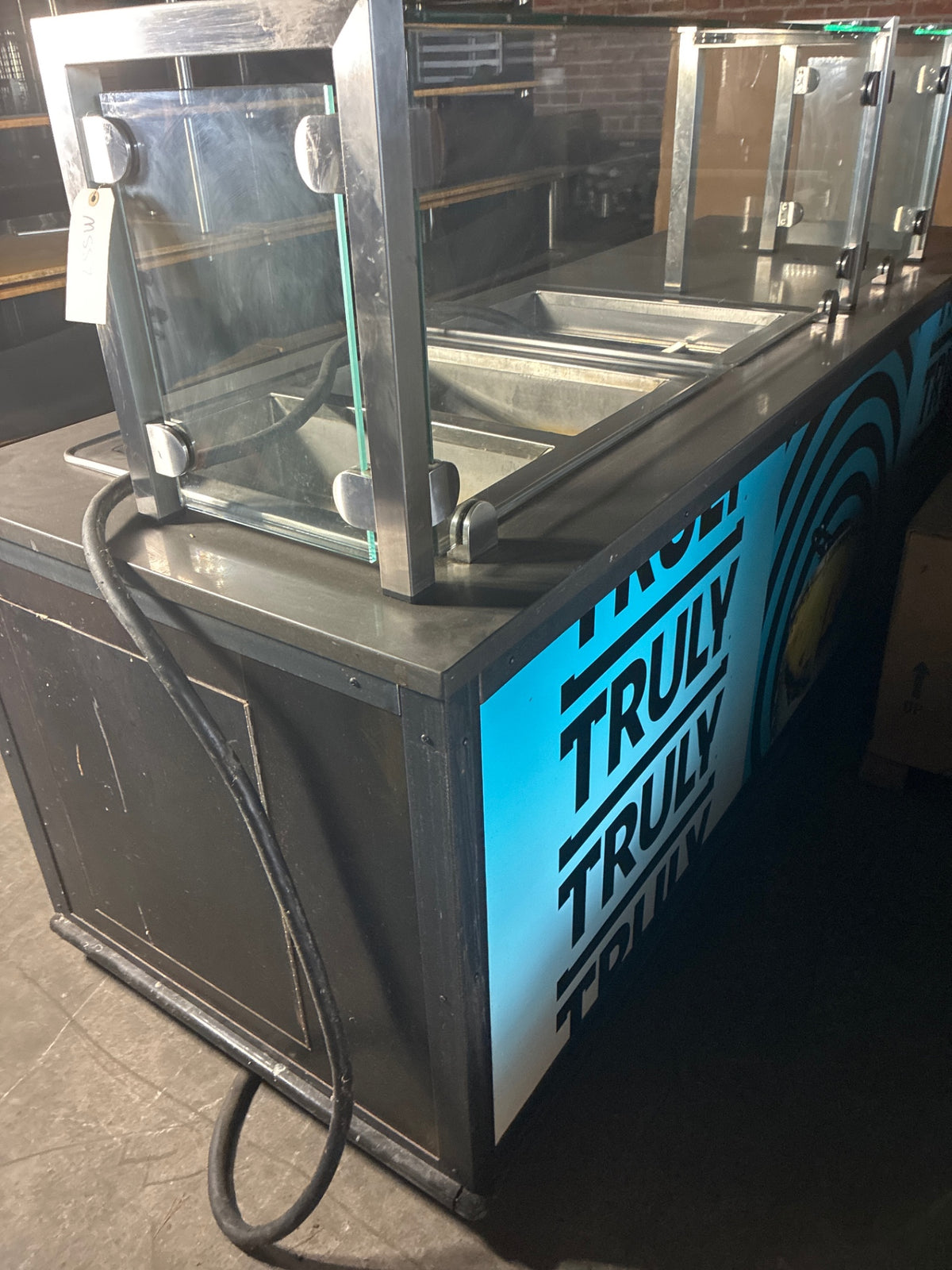 Partners By Design 01-02062528 Action Station, 2 Hot Wells, 1 Cold Well, Sneeze Guard W/ Register Station, Under Storage, Mobile
